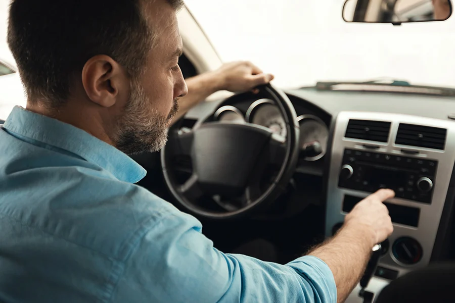 A Person Driving A Car And Listening To A Satellite Radio a person driving a car and listening to a satellite radio