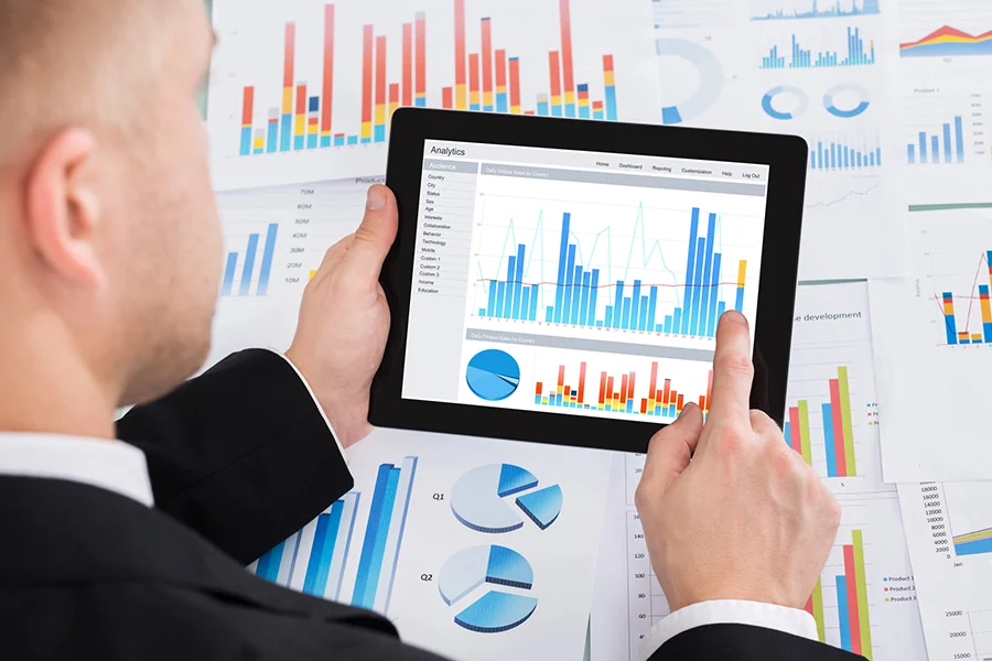 Business Professional Reviewing Performance Data On A Tablet, Illustrating The Impact Of Local Advertising By Cable Tv Providers business professional reviewing performance data on a tablet, illustrating the impact of local advertising by cable tv providers