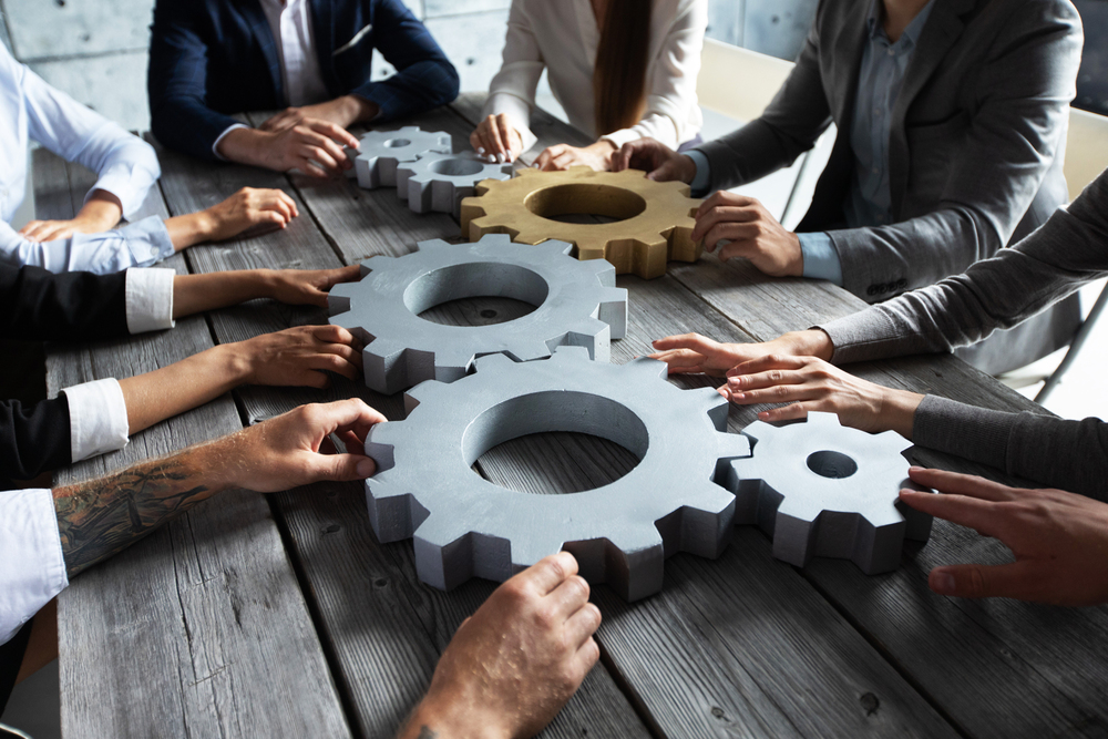 Dwd Technology Group Partners With Lead To Conversion For Digital Marketing Growth 5 business people joining gears like dwd and ltc