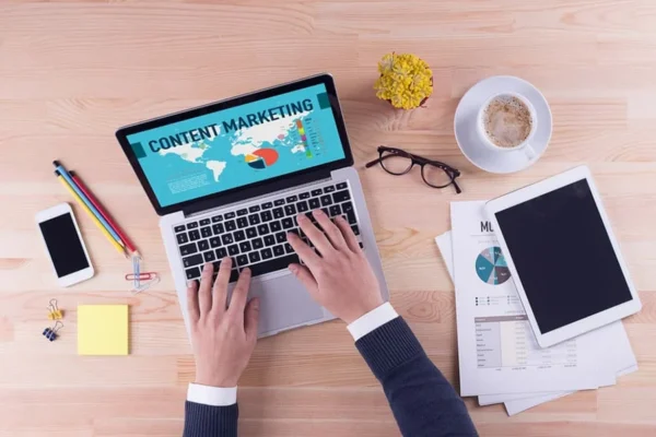 man typing on laptop writing content concept image for franchise business using content marketing to get online reviews