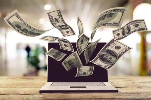 Money coming out of laptop concept image for Lead to Conversion's franchise digital marketing building a profitable brand