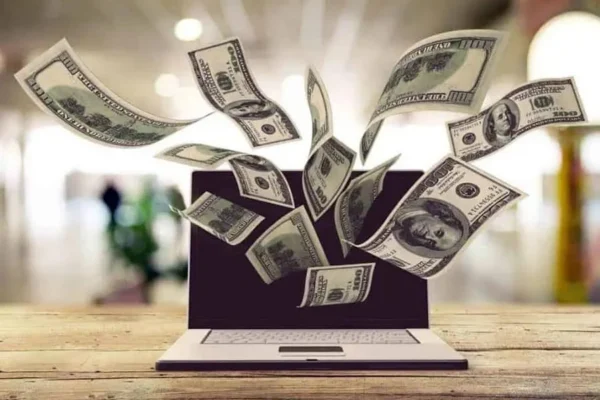 Brand Vs. Franchise Marketing: Is There A Difference? 3 money coming out of laptop concept image for lead to conversion's franchise digital marketing building a profitable brand