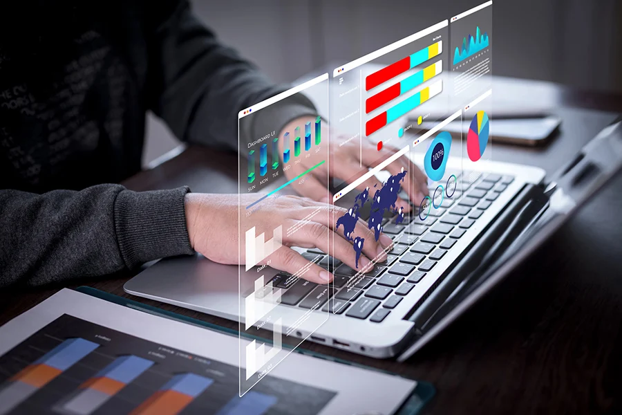 person analyzing digital data on a laptop with futuristic charts and graphs, related to network broadcast tv advertising