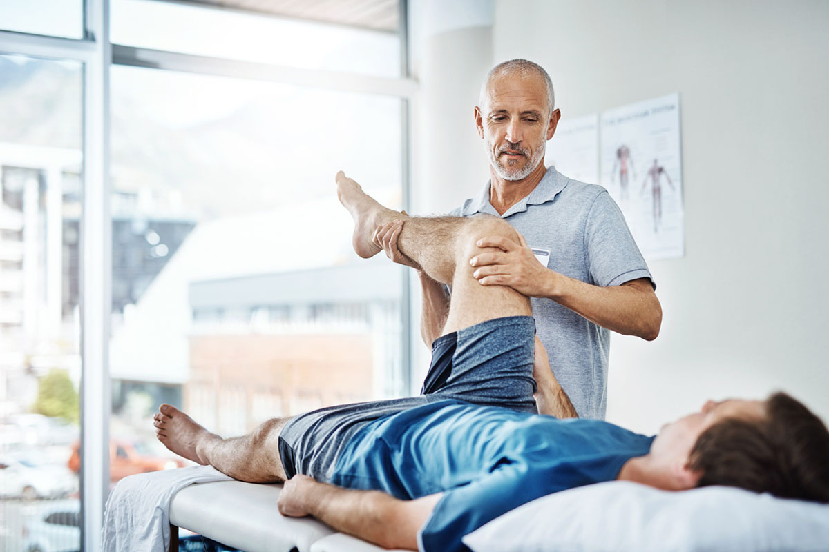 Physical therapist helping his patient image concept for physical therapy social media marketing.