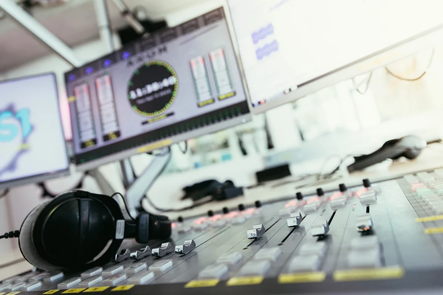 radio broadcasting studio soundboard and computers