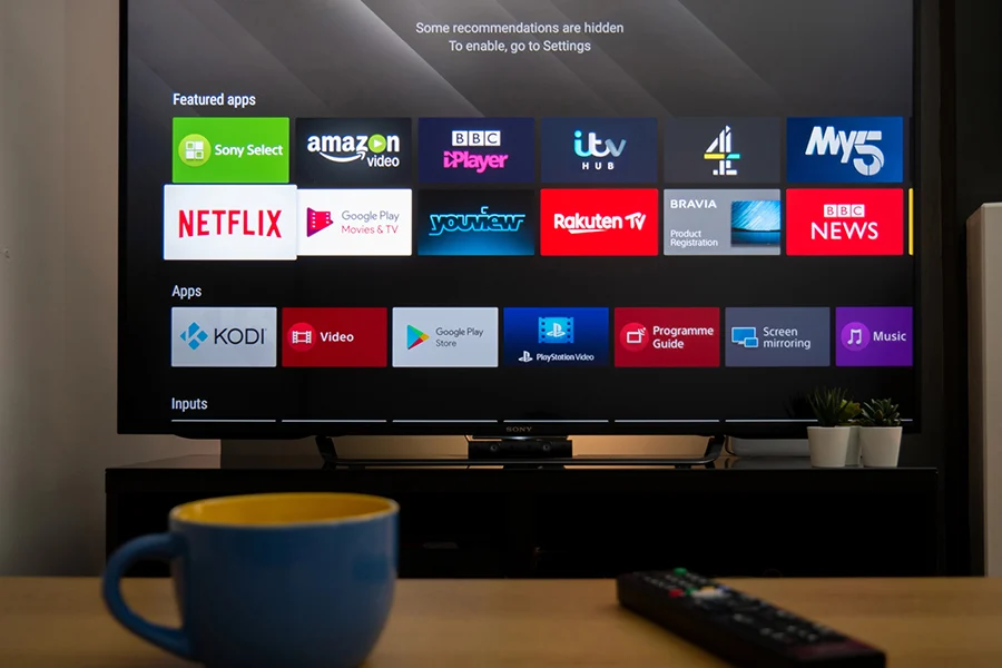 smart tv screen displaying various streaming apps like netflix, amazon video, and bbc iplayer, with a focus on streaming tv advertising
