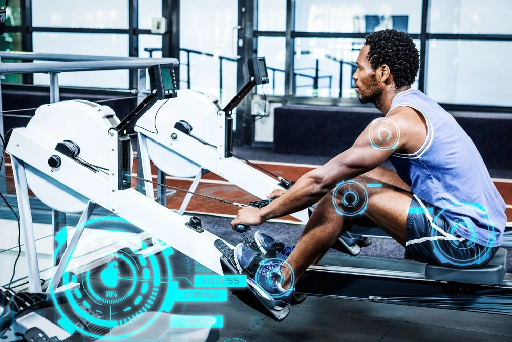 Man Working Out In Gym Against Fitness Interface adult male using a rower machine at a high tech gym