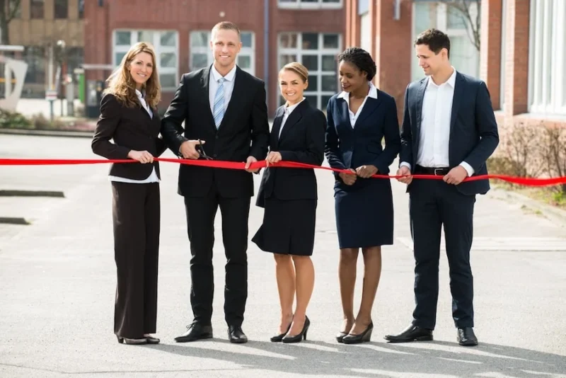 How To Choose A Franchise Marketing Agency 3 a proud franchise owner team standing in front of their new store location for a ribbon cutting ceremony. they know the value of asking