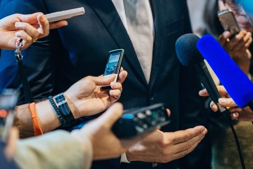 businessman being interviewed by press as part of a pr campagn