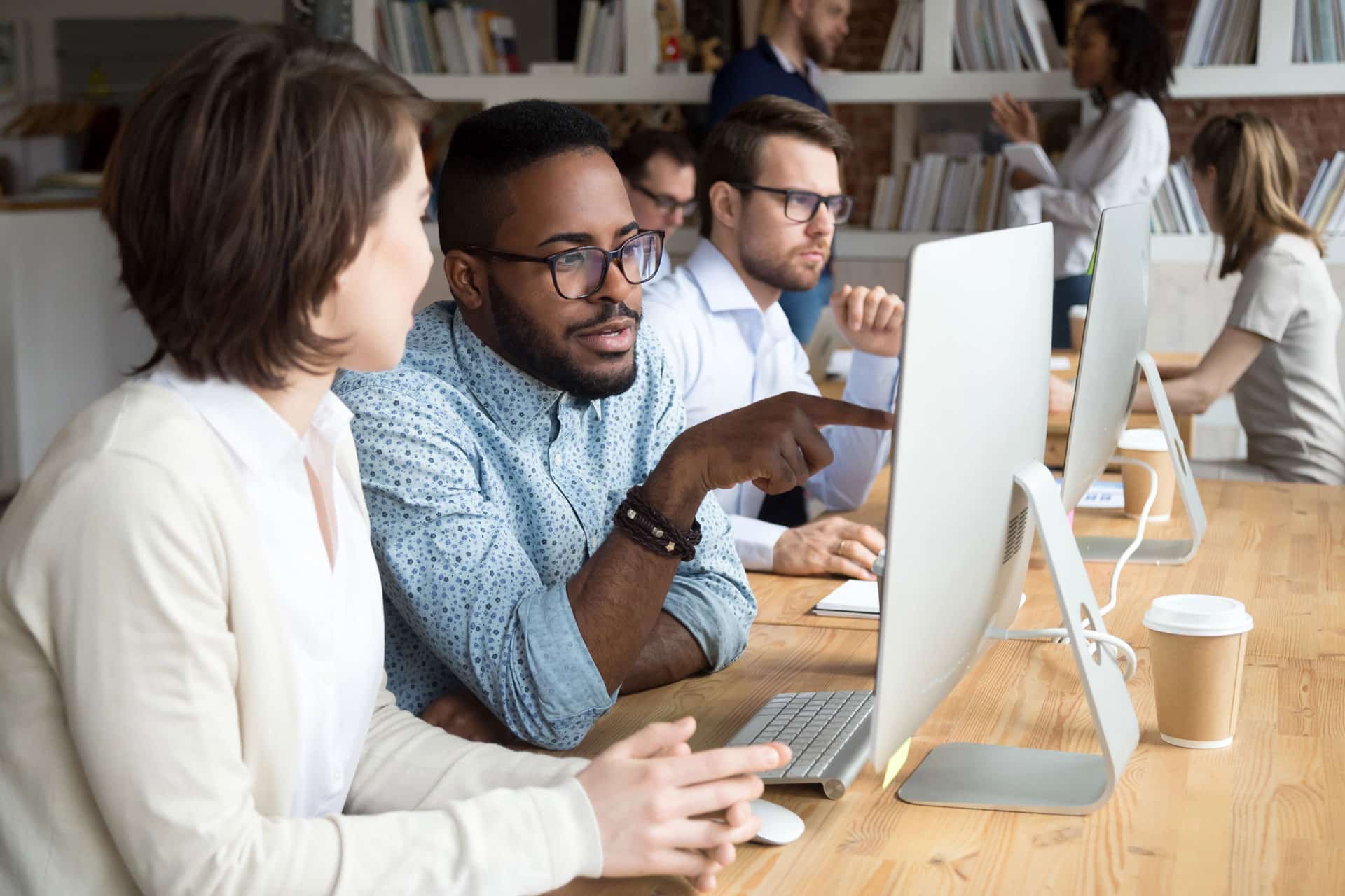 male and female team members working on a multi-location CRO project