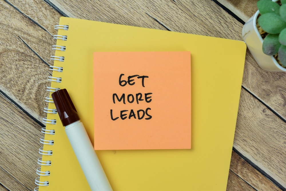 notebook with sticky note with get more leads written