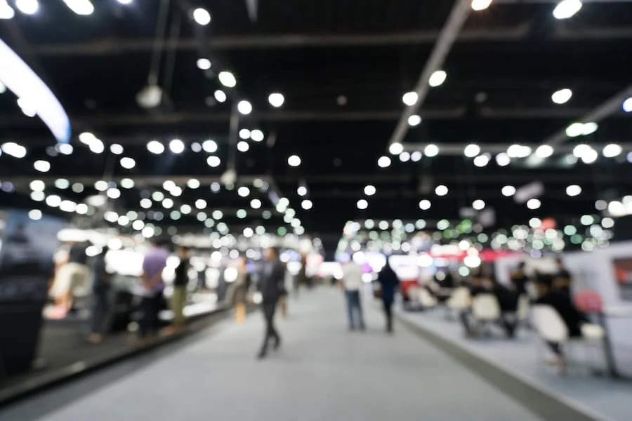 exhibitors and entrepreneurs networking at a bustling franchise expo, exchanging business cards.