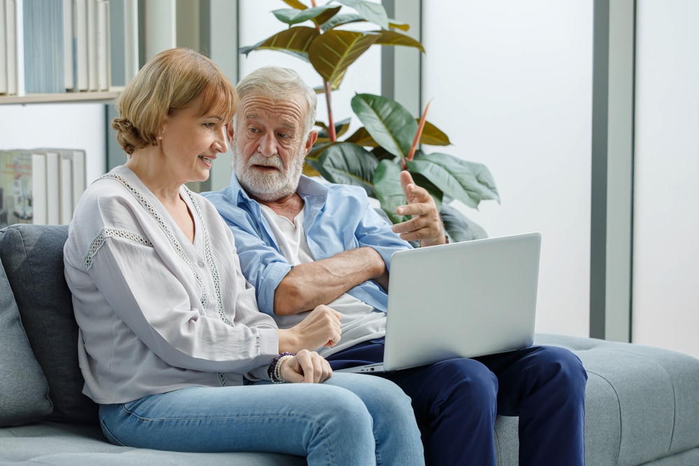 seniors checking the assisted living website design of a senior facility and making a decision based on it