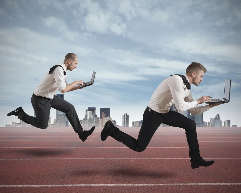 two men running on track on laptops comparing growth driven design and conversion rate optimization