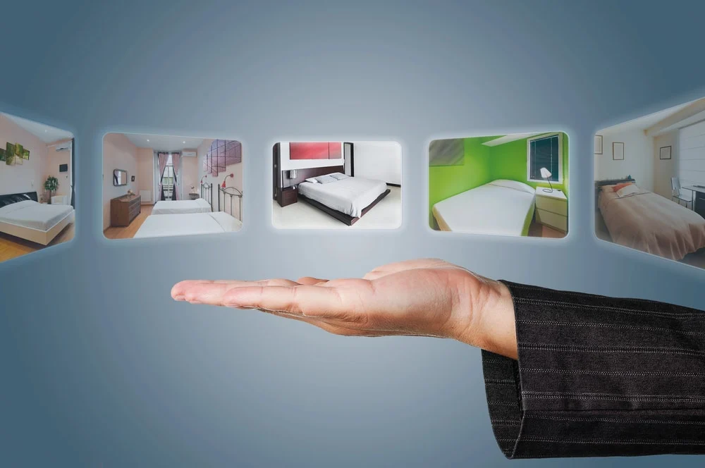 Woman-In-Suit-Holding-Hand-Over-Hotel-Room-Options woman in suit holding hand over hotel room options